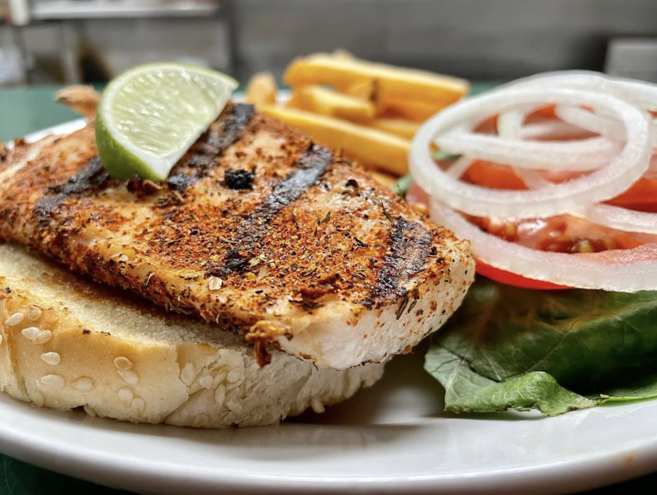 Mahi mahi sandwich with fries and lime