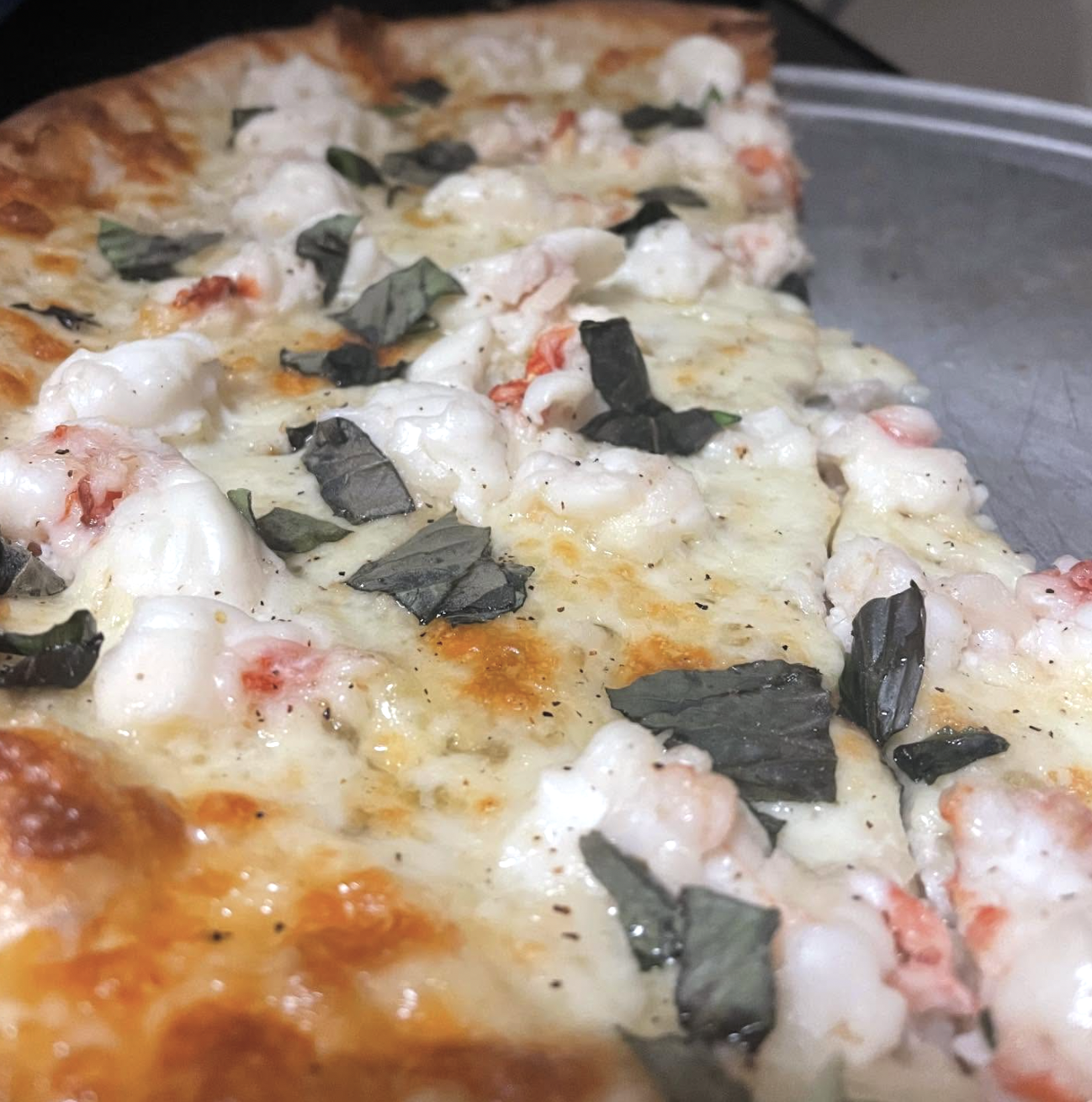 Shrimp and lobster pizza with fresh basil at Son of a Pizza Pub
